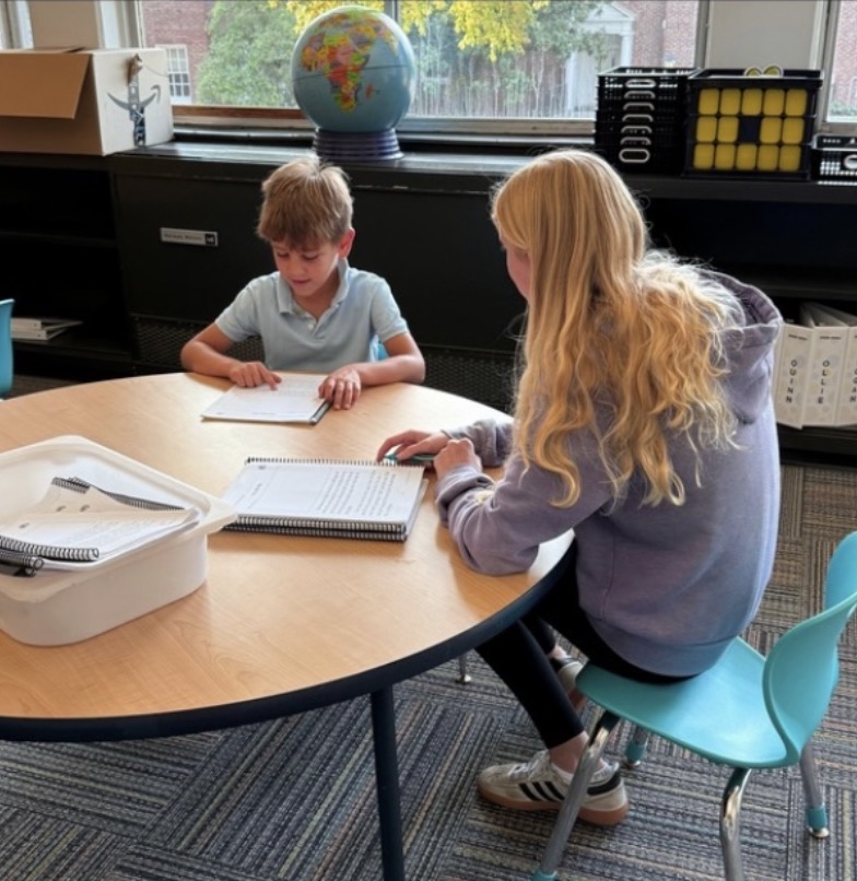 Sophomore Josephine Burroughs with a Doherty grade schooler