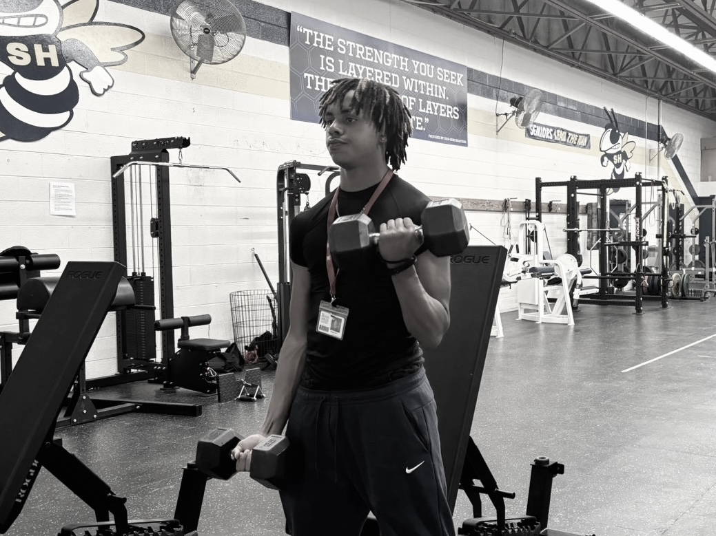 Senior Vaughn Iyoha lifting weights in the Seven Hills workout room. 